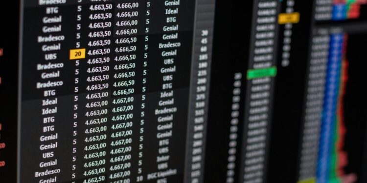 Traders monitor stock market trends amid concerns over AI earnings reports on Wall Street.