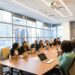 JPMorgan and Huawei representatives discussing AI governance at a roundtable meeting.