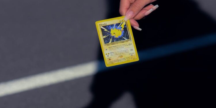 Logan Paul holds the rare Pikachu Illustrator card during a recent auction event.