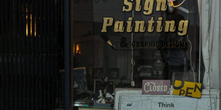 A struggling small crypto venue sign outside a closed storefront.