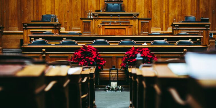 Igor Runets, CEO of BitRiver, seated with handcuffs during a court hearing.