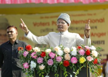Senator Blumenthal speaking at a podium, addressing topics of finance and crypto regulation.