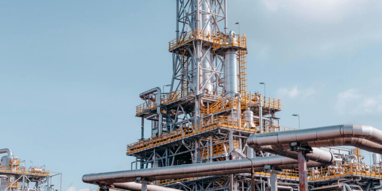 Citgo oil refinery with Venezuelan flag, symbolizing a shift in U.S. oil policy.
