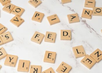 Graphic showing Federal Reserve building with financial symbols and public comment invitation.