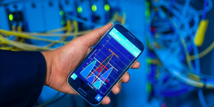 A tech team monitors screens showing crypto transaction data in a server room.