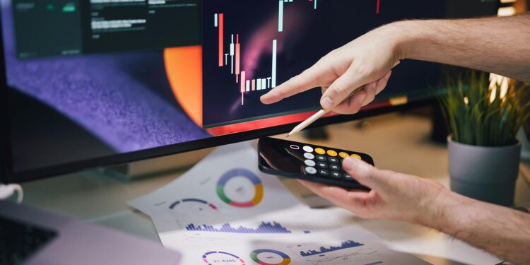 A digital display showing stock market graphs and prediction market statistics.
