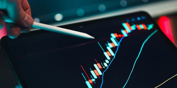 A person analyzing cryptocurrency market trends on a computer screen with financial graphs.