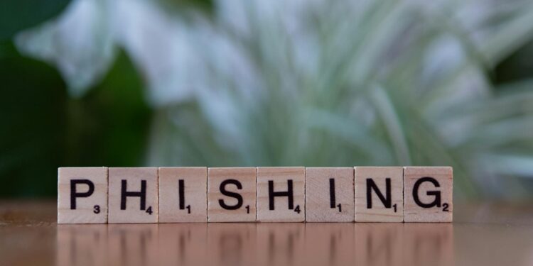 A hardware wallet surrounded by phishing emails and alerts, highlighting crypto security concerns.