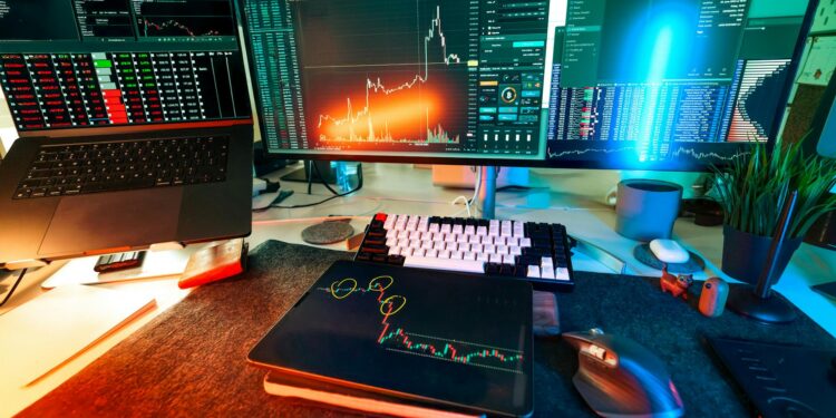 A businessman analyzes Bitcoin trends on multiple screens in a modern office setting.