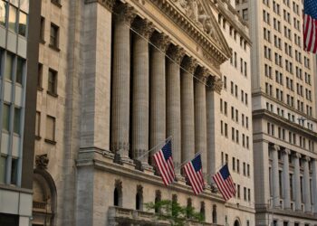 A bustling New York Stock Exchange with traders surrounding a large RedotPay banner.