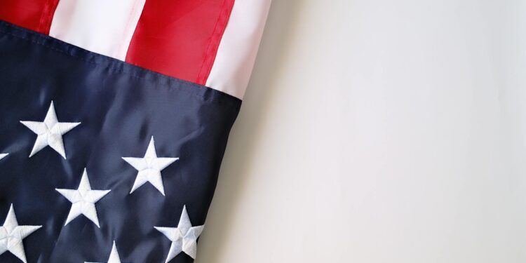 Gemini logo with US flag backdrop, illustrating its shift focus to the US market amid job cuts.