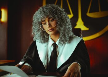 A courtroom scene with legal documents and a laptop reflecting stock data analysis.