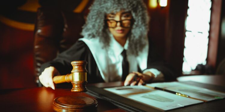 A gavel rests on a legal document beside a Bitcoin symbol, symbolizing crypto fraud sentencing.