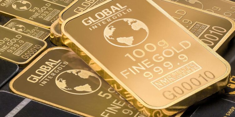 Tether executive discussing investment strategy with gold bars in the background.