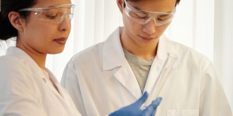 Scientists collaborate with AI tools, analyzing data on screens in a modern lab setting.