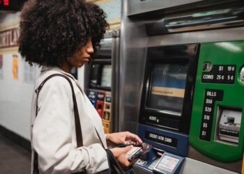 Person using a smartphone with a Bitcoin wallet interface for ticket purchasing.