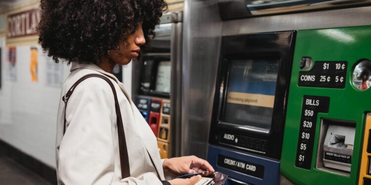 Person using a smartphone with a Bitcoin wallet interface for ticket purchasing.