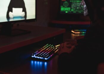 A hacker manipulating code on a computer screen, representing cyber security threats in crypto.