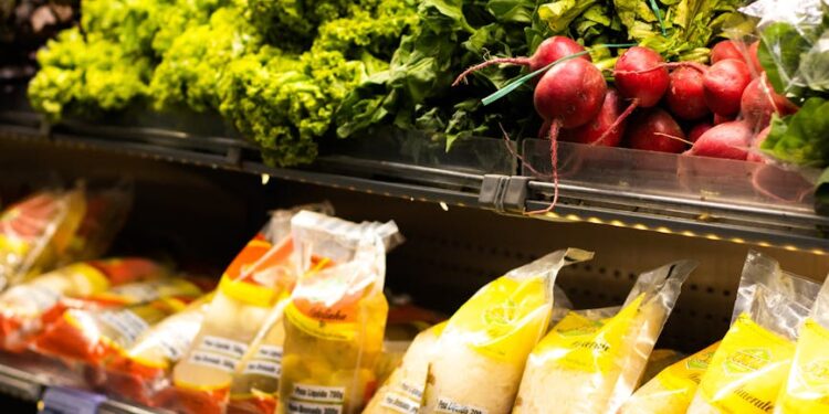 A bustling grocery store with shelves stocked with fresh produce and staple foods.