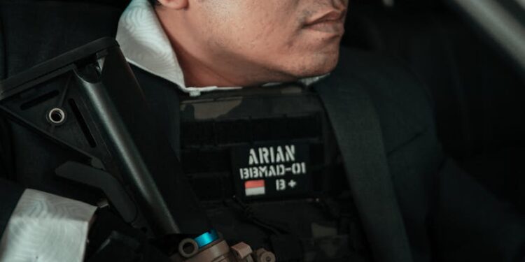FBI agents in tactical gear arrest a man outside a tech office, dark web implications looming.