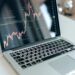 A financial analyst reviews cryptocurrency charts and perpetual futures data on a digital screen.