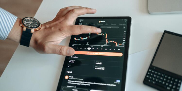 A trader analyzes Bitcoin trends on a digital screen with charts and financial data visible.