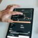 A trader analyzes Bitcoin trends on a digital screen with charts and financial data visible.