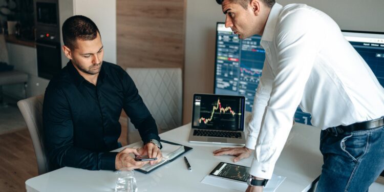 Modern office scene with professionals discussing cryptocurrency finance strategies.