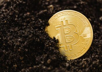 Bitcoin mining equipment in a dimly lit facility, showcasing cryptocurrency operations.