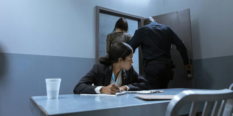 Two teens being escorted by police outside a Scottsdale home during a crypto-related investigation.