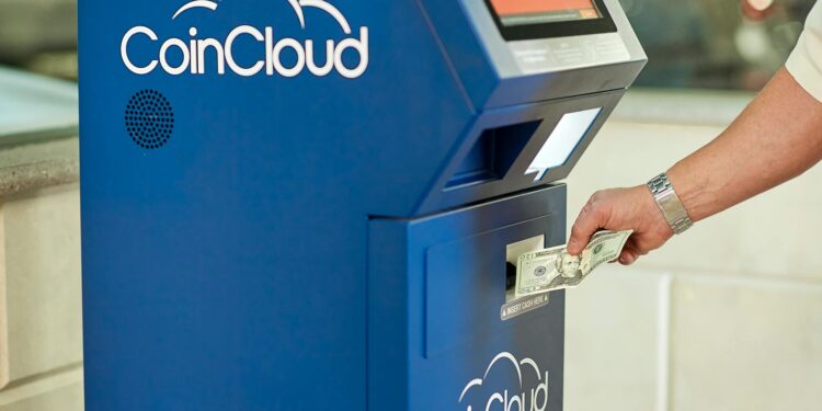 A crypto ATM displaying Bitcoin logos surrounded by financial scam warning signs.