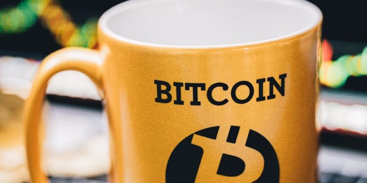 A trader analyzing cryptocurrency charts on a laptop, with Bitcoin and DeFi symbols visible.