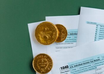 Cryptocurrency coins and tax documents symbolize new EU reporting regulations.