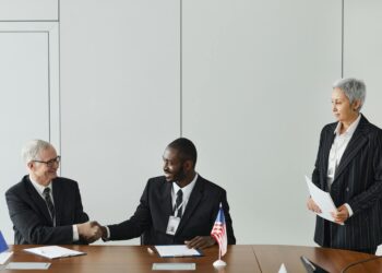 MARA Holdings and Starwood executives shake hands at a signing ceremony for AI data centers.