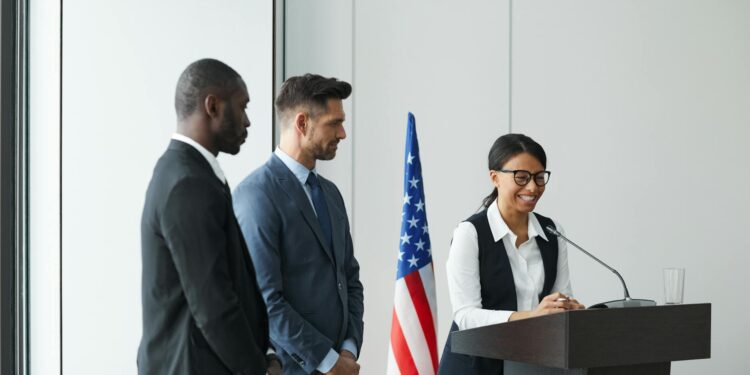 Group of fintech representatives speaking at a podium during a Federal Reserve meeting.