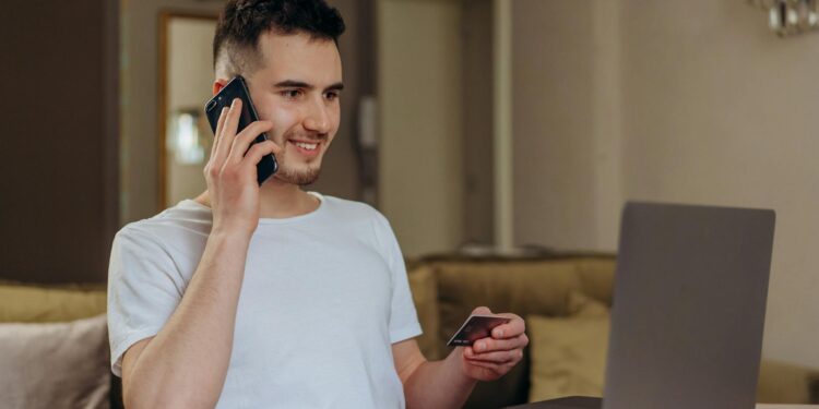 A person using a smartphone to make a purchase with stablecoins at a cafe.