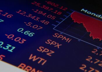 Stock market ticker shows a sharp decline, reflecting the Dow Jones fall amid tariff news.