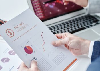 A financial expert discusses stablecoin regulations at a conference with charts displayed.