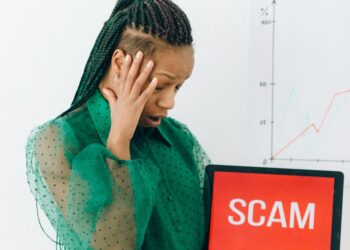 A person holding a smartphone with Revolut’s logo, concerned about data security.