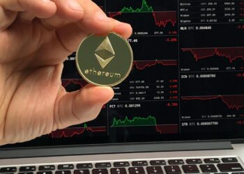 A digital representation of Ethereum coins with financial charts in the background.