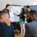 A diverse group of entrepreneurs presents at a crypto pitch competition in Hong Kong.