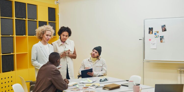 A group of diverse entrepreneurs discusses crypto strategies in a modern office space.