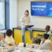 A diverse group of professionals discusses the new Forex remittance platform launch.