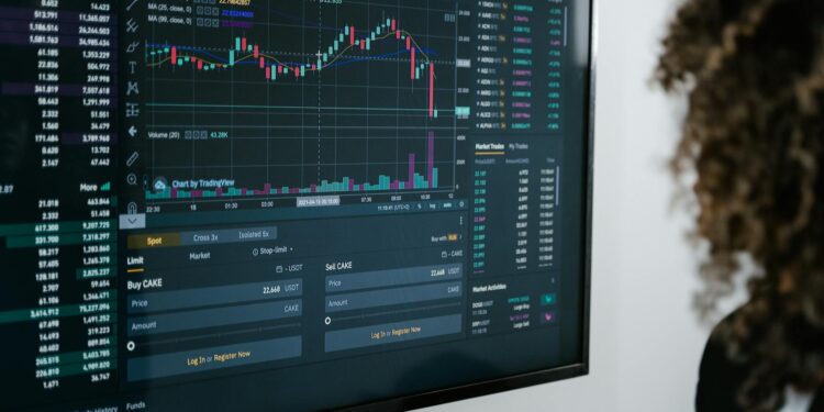 A trader analyzing Bitcoin price charts on multiple screens amidst digital currency graphics.