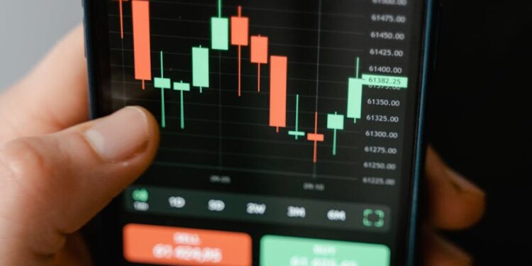 Smartphone displaying a trading app interface with cryptocurrency charts and graphs.