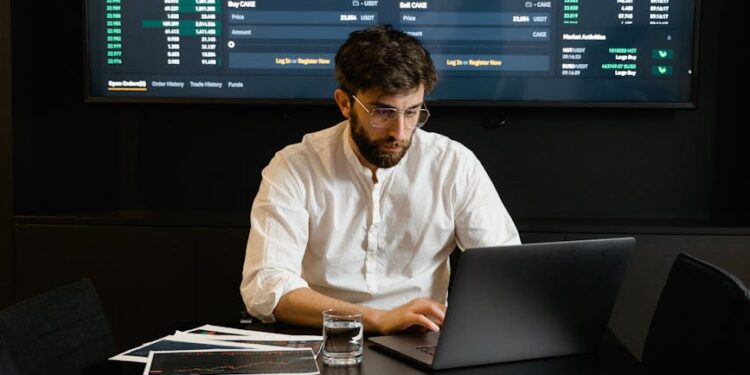 A trader analyzes Bitcoin prices on a digital exchange amidst news of DeFi liquidity issues.