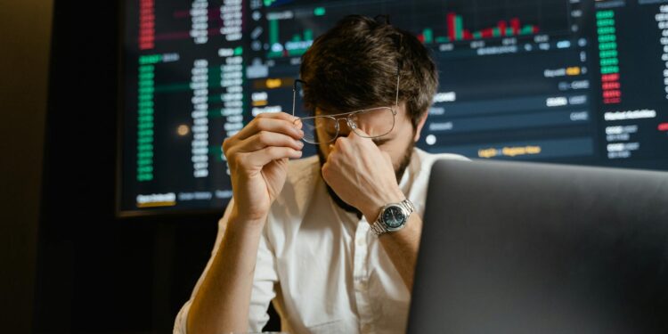 A trader monitors cryptocurrency charts as Bitcoin rises to new heights.