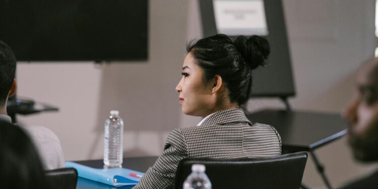 SEC Chair sitting at a conference table discussing potential regulations on prediction markets.
