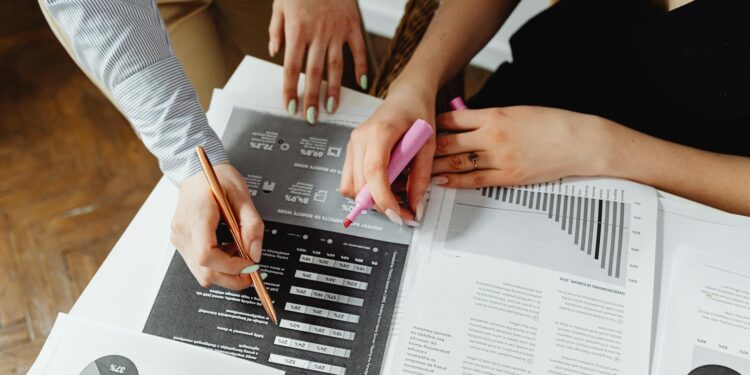 Financial professional reviewing documents with cryptocurrency graphics in the background.