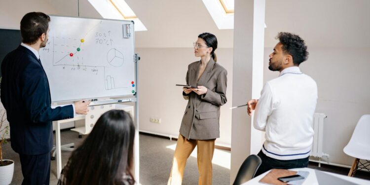 A diverse group of entrepreneurs discussing blockchain projects in a modern office space.